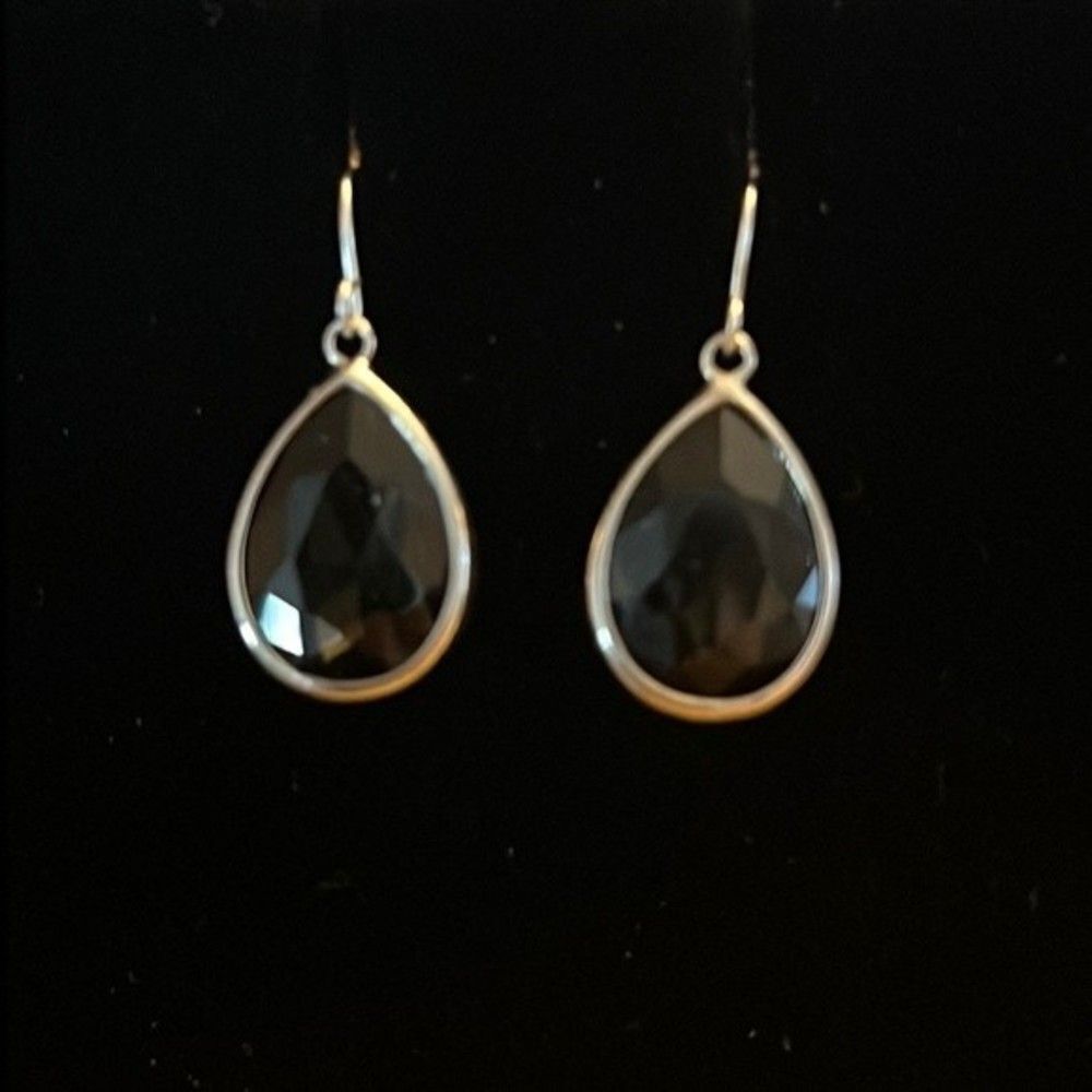 Handcrafted silver tone earrings with a Smokey colored stone.